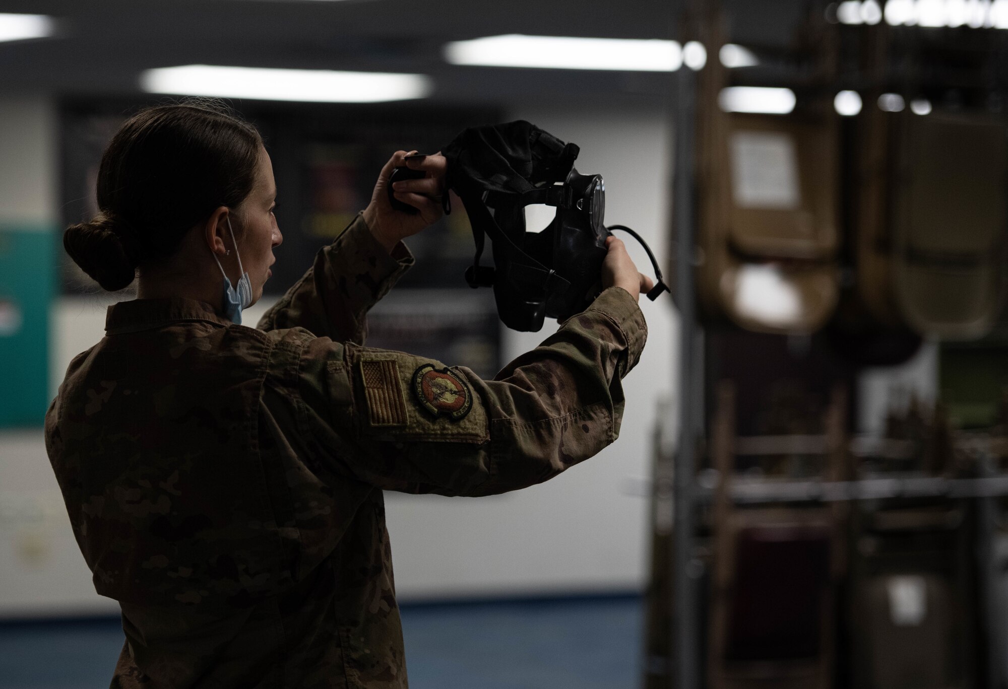 Airman holds protective gas mask.