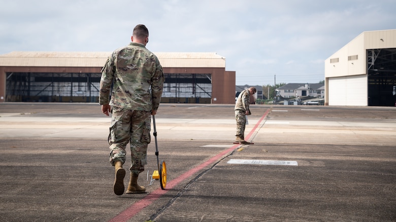 Master Sgt. Justin Consley 2nd Security Forces Squadron flight chief, and Master Sgt. Anton Hinrichsen, 2nd SFS technology and resources NCO in-charge, set up a cordon area for Global Thunder 21 at Barksdale Air Force Base, La., Oct. 20, 2020.