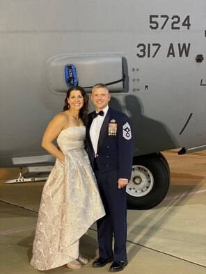 Julie Umfleet, left, and Chief Master Sgt. Mark Umfleet, 317th Airlift Wing command chief, pose for a photo at the Air Force Ball at Dyess Air Force Base, Texas, Oct. 7, 2020. The Umfleets posed infront of a static C-130J Super Hercules. (U.S. Air Force courtesy photo)