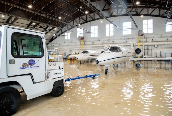 A towing truck operator gets ready to move a C-21 Lear Jet from a hangar at Scott Air Force Base, Illinois, Aug. 12, 2020.