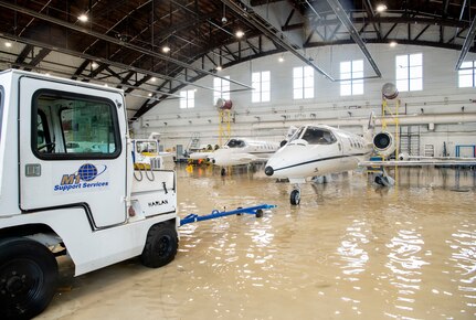 A towing truck operator gets ready to move a C-21 Lear Jet from a hangar at Scott Air Force Base, Illinois, Aug. 12, 2020.