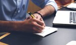 Man writing on notepad