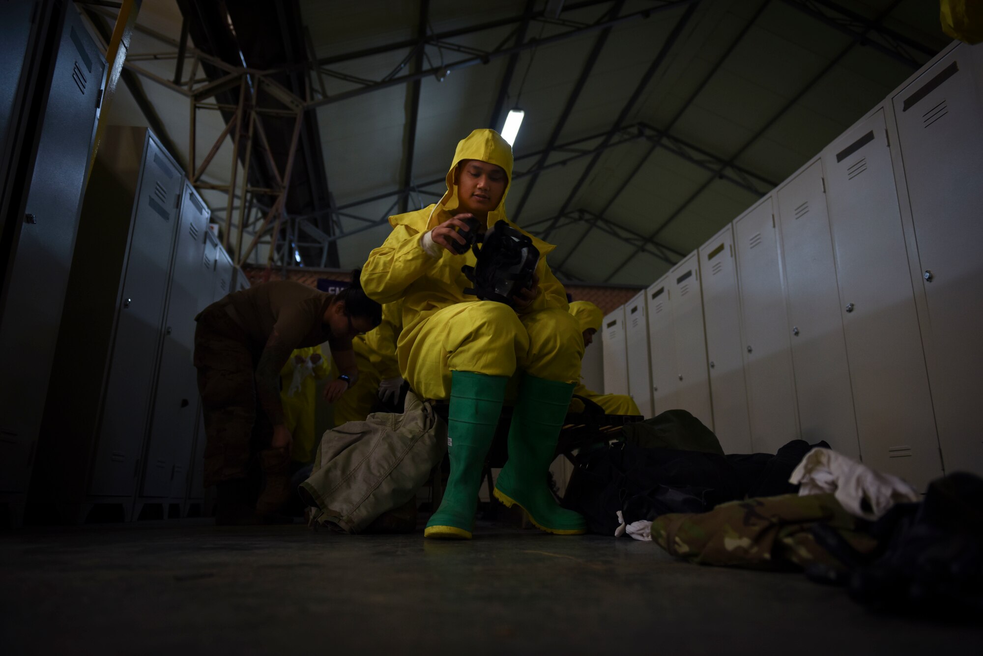 Photo of an Airman attaching a filer to his gas mask