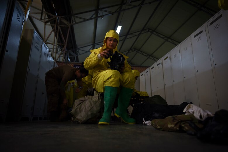 Photo of an Airman attaching a filer to his gas mask