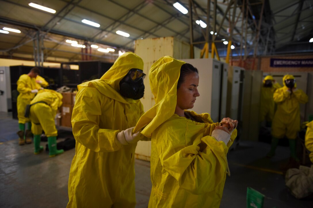 Photo of Airmen donning protective gear