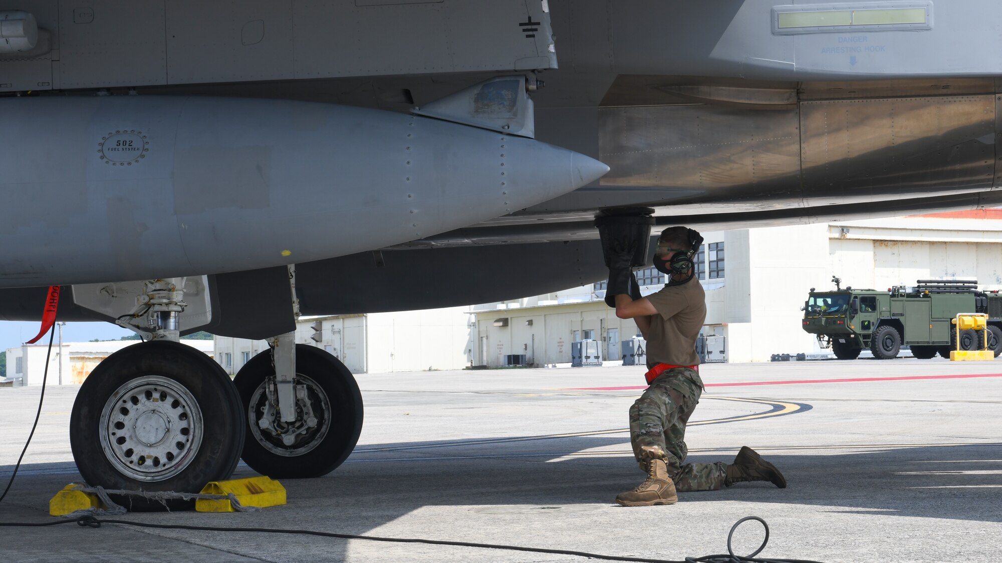 An Airman from the 18th Logistics Readiness Squadron prepares to refuel an F-15C Eagle during Exercise WestPac Rumrunner at Marine Corps Air Station Futenma, Japan, Oct. 16, 2020. The forward air refueling point mission supports contingency and exercise operations to refuel aircraft and equipment in austere locations where typical air-to-air refueling or established refueling stations are not available. “We’re testing our capabilities with the F-15 and the mechanic’s ability to deploy to a forward operating location,” said U.S. Air Force Master Sgt. Jeff Farris, 67th Aircraft Maintenance Unit production superintendent. “We’re doing FARP operations here, which is refueling off the back of a C-130 as well as loading missiles onto the center-body of the two F-15s.” (U.S. Air Force photo by Staff Sgt. Benjamin Raughton)