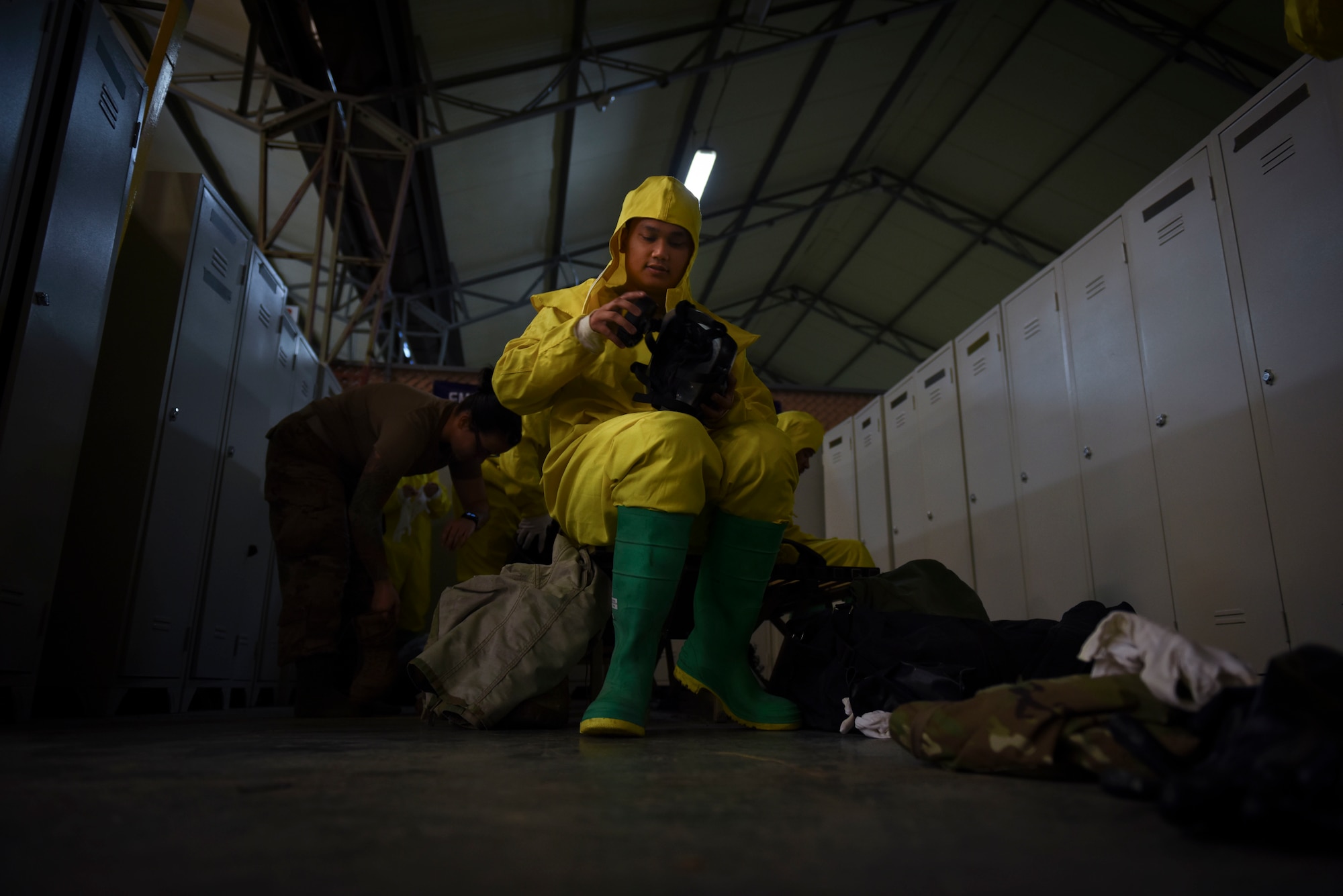 Photo of an Airman attaching a filer to his gas mask