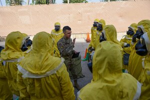 Photo of an Airman giving a briefing to exercise participants