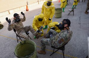 Photo of Airmen performing decontamination procedures