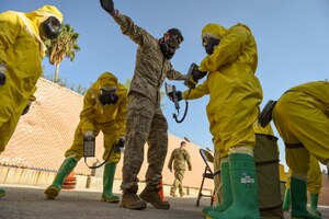 Photo of Airmen performing decontamination procedures