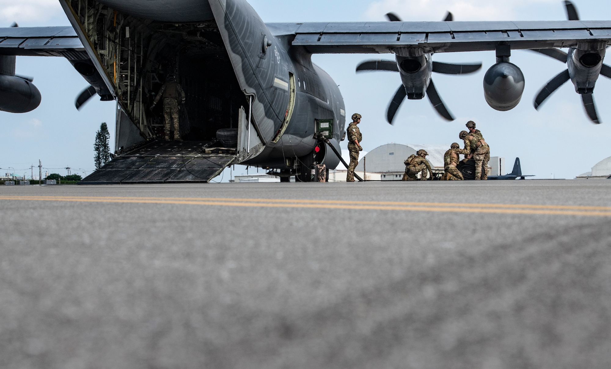 U.S. Air Force Airmen from the 353rd Special Operations Group and 18th Logistic Readiness Squadron roll up a fuel line after refueling aircraft during forward area refueling point operations for the third iteration of Exercise WestPac Rumrunner Oct. 16, 2020, at Kadena Air Base, Japan. “Ground personnel and aircrew practiced alert scrambles and forward air refueling operations of F-15 and F-16 aircraft from C-130s, an essential part of PACAF’s focus on agile combat employment,” said Lt. Col. Craig Van Beusekom, Rumrunner 3.0 airboss and 67th Fighter Squadron commander. The FARP mission supports contingency and exercise operations to refuel aircraft and equipment in austere locations where typical air-to-air refueling or established refueling stations are not available. (U.S. Air Force photo by Tech. Sgt. Micaiah Anthony)