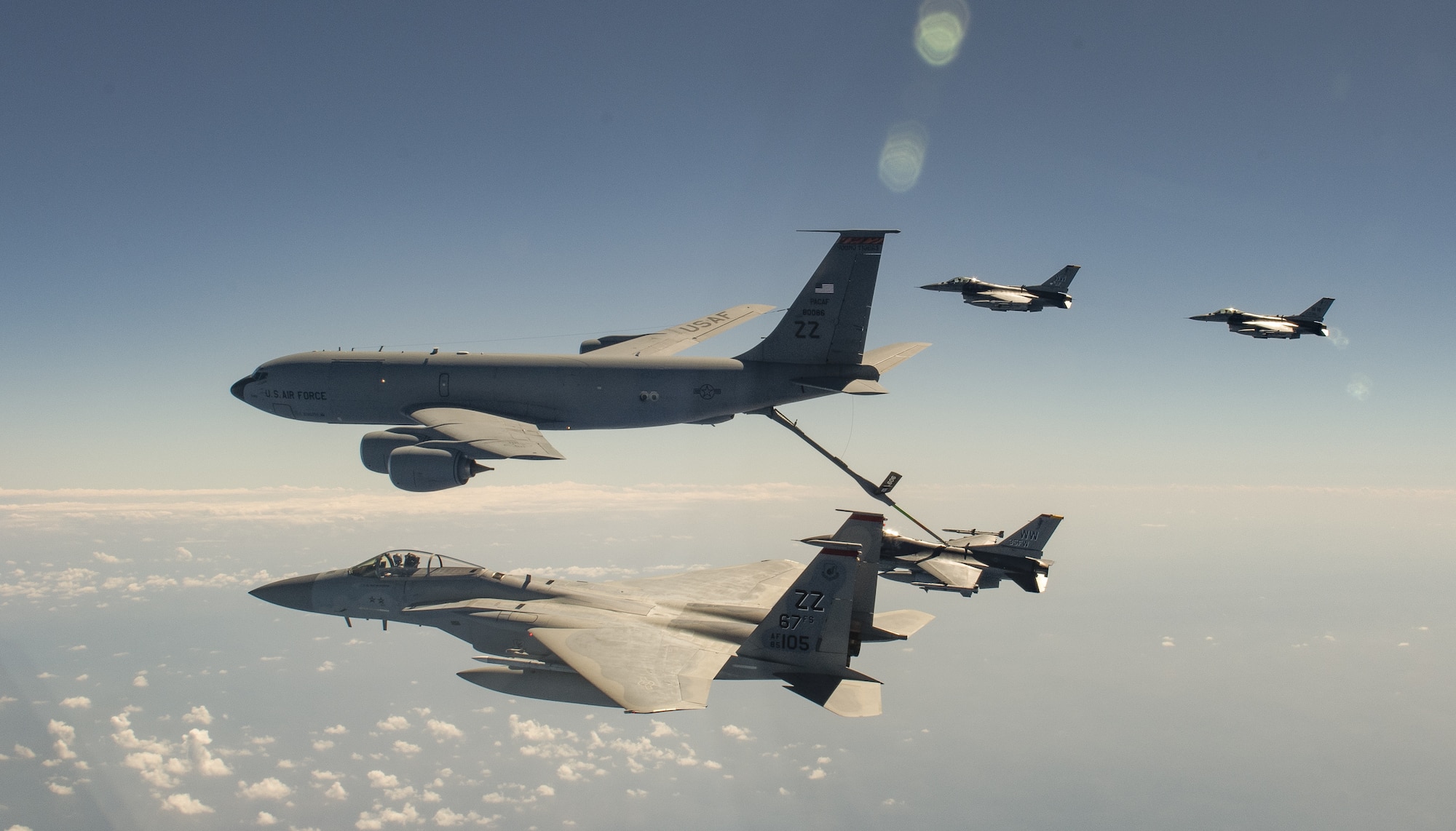 A U.S. Air Force KC-135 Stratotanker from the 909th Air Refueling Squadron refuels U.S. Air Force F-16 Fighting Falcons from the 35th Fighter Wing, Misawa Air Base, Japan and a U.S. Air Force F-15C Eagle from the 67th Fighter Squadron while participating in Exercise Westpac Rumrunner, out of Kadena Air Base, Japan, Oct. 16, 2020. The 18th Wing executed the third iteration of Exercise WestPac Rumrunner with joint partners with a focus on improved interoperability and fine-tuning of agile combat employment concepts. ACE is the cornerstone of the wing’s operating concept. It enables forces to operate from locations with varying levels of capacity and support, ensuring multi-capable Airmen are postured in a position of advantage to generate combat power. (U.S. Air Force photo by Tech. Sgt. Daniel E. Fernandez)