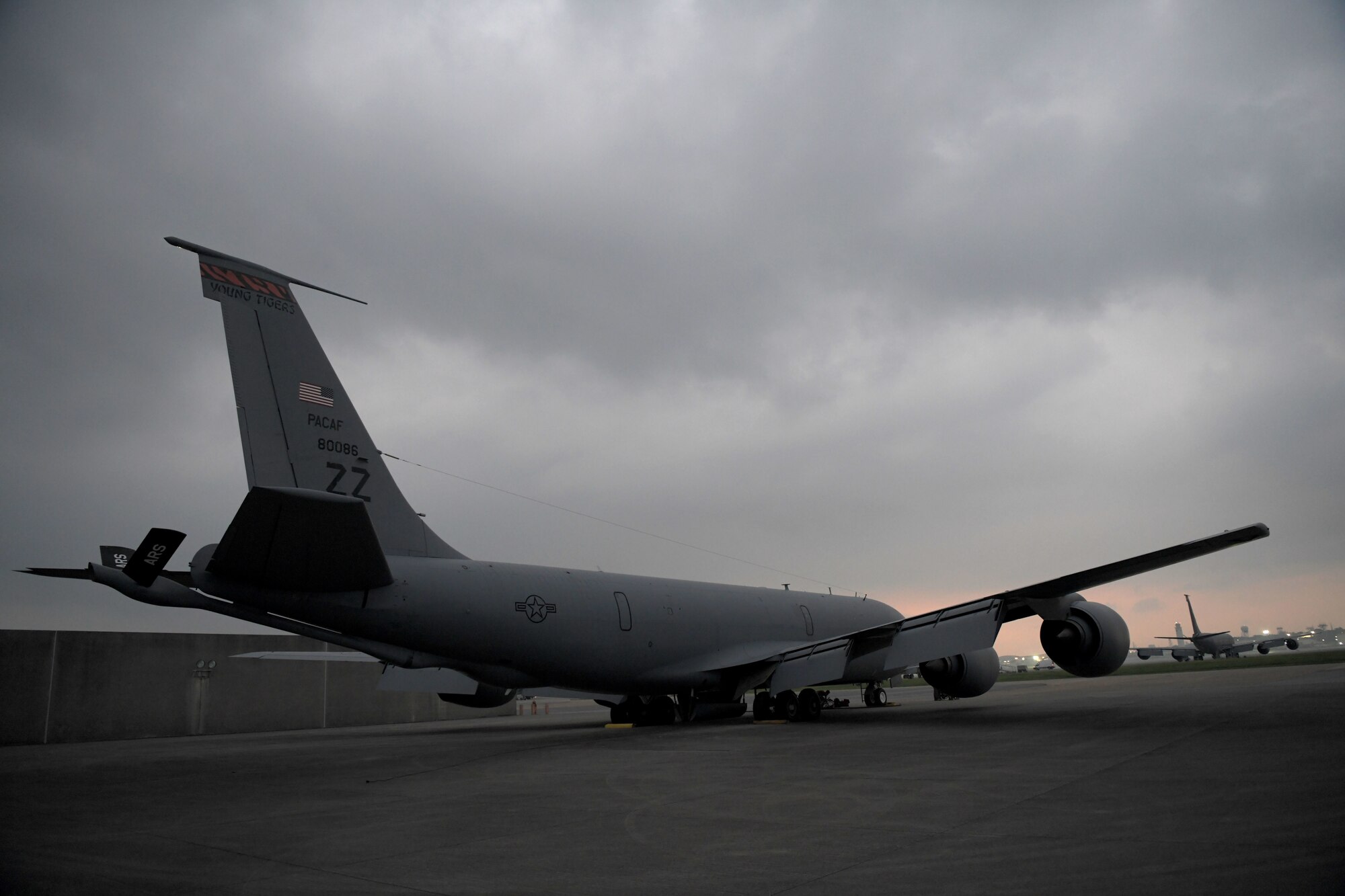 A KC-135 Stratotanker from the 909th Air Refueling Squadron is peacefully parked on the flightline while the rest of Kadena Air Base slowly awakes for Exercise WestPac Rumrunner, Oct. 16, 2020 at Kadena Air Base, Japan. Aerial refueling magnifies the reach of military assets and ensures forward-deployed forces in the Indo-Pacific are ready to protect and defend partners, allies and U.S. interests at a moment’s notice. This exercise tested the 18th Wing’s ability to project air power across a vast distance and defend different aircraft performing multiple mission sets. (U.S. Air Force photo by Airman 1st Class Rebeckah Medeiros)