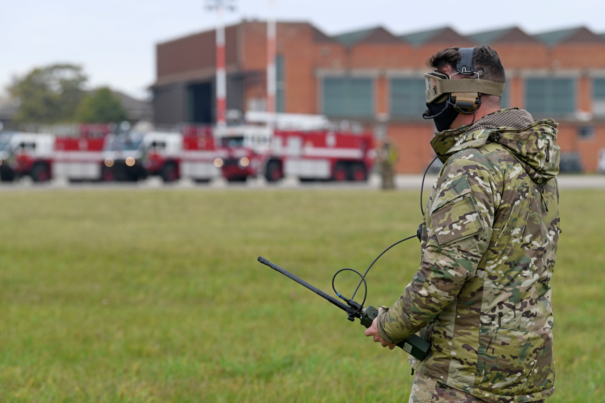 An Airman assigned to the 752nd Special Operations Aircraft Maintenance Squadron uses a radio to communicate to inbound aircraft during emergency landing training at Royal Air Force Mildenhall, England, Oct. 19, 2020. The training prepared maintainers and CV-22 Osprey aircraft aircrew to conduct emergency landing in the event of a landing gear malfunction. (U.S. Air Force photo by Staff Sgt. Mackenzie Mendez)