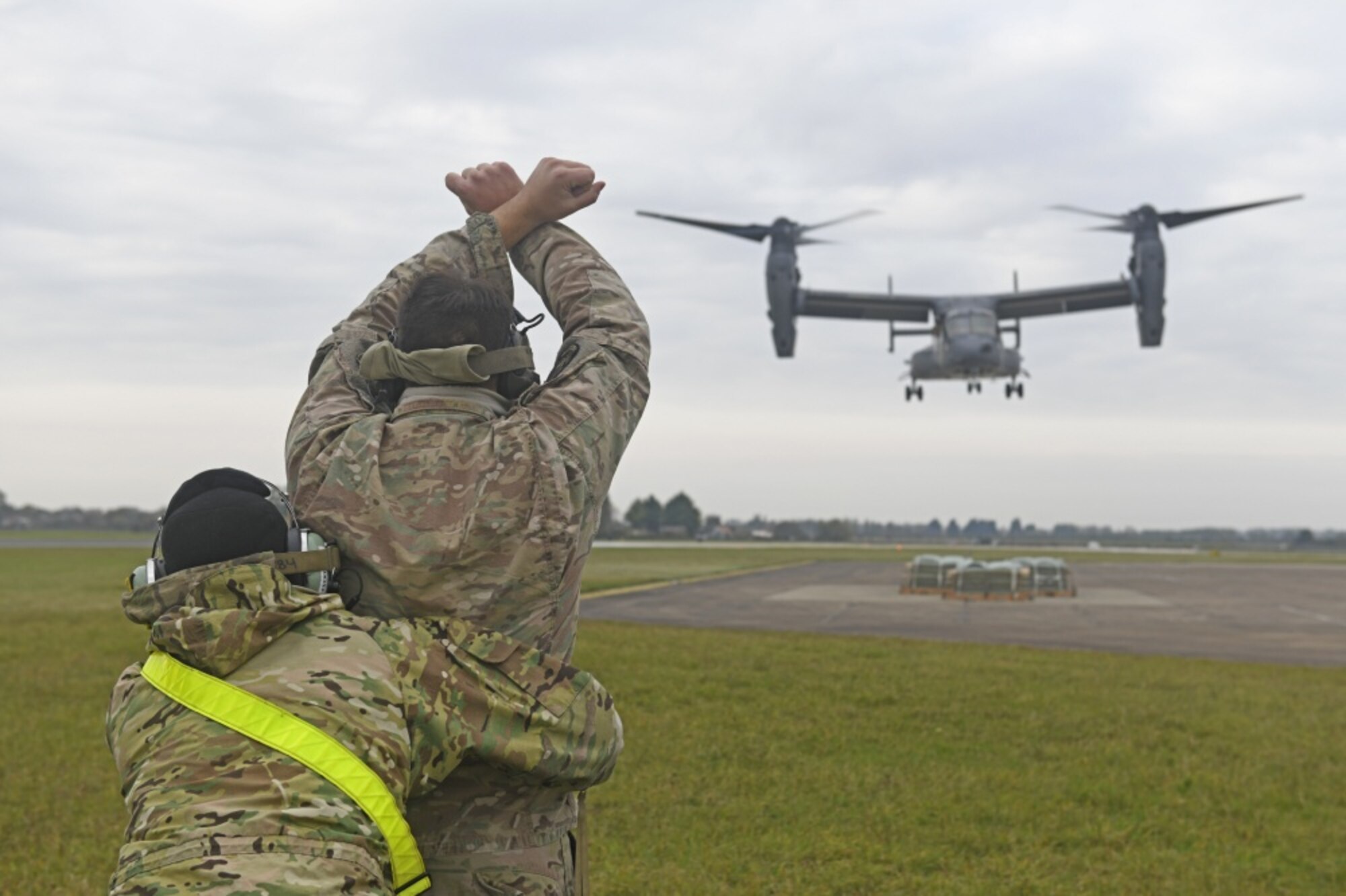 Airmen assigned to the 752nd Special Operations Aircraft Maintenance Squadron guide a CV-22 Osprey aircraft during emergency landing training at Royal Air Force Mildenhall, England, Oct. 19, 2020. The training focused on preparing CV-22 aircrew and maintainers to land the aircraft on a set of aircraft mattress pads in the event of a landing gear malfunction. (U.S. Air Force photo by Staff Sgt. Mackenzie Mendez)