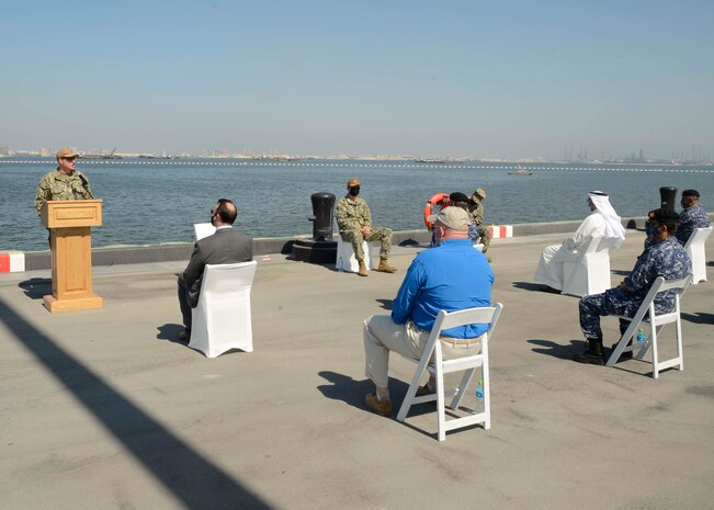 MANAMA, Bahrain (Oct. 21, 2020) Capt. Greg Smith, commanding officer, Naval Support Activity (NSA) Bahrain, speaks during a ribbon cutting ceremony celebrating the installation of the coalition maritime forces waterfront security barrier at the Mina Salman Pier on board NSA Bahrain. The barrier is the first water-limited obstacle system security barrier system ever installed at an overseas naval installation, and the longest waterside security barrier in the U.S. Navy. NSA Bahrain enables the forward operations and responsiveness of U.S. and allied forces in support of Navy Region Europe, Africa, Central’s mission to provide services to the fleet, warfighter and family. (U.S. Navy photo by Mass Communication Specialist 1st Class Justin Yarborough)