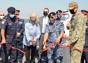 MANAMA, Bahrain (Oct. 21, 2020) Maggie Nardi, U.S. Embassy Chargé d’Affaires to the Kingdom of Bahrain, center, cuts a ribbon with Rear Adm. Curt Renshaw, deputy commander, U.S. Naval Forces Central Command, right, along with senior military and host nation leadership at a ceremony celebrating the installation of the coalition maritime forces waterfront security barrier at the Mina Salman Pier on board NSA Bahrain. The barrier is the first water-limited obstacle system security barrier system ever installed at an overseas naval installation, and the longest waterside security barrier in the U.S. Navy. NSA Bahrain enables the forward operations and responsiveness of U.S. and allied forces in support of Navy Region Europe, Africa, Central’s mission to provide services to the fleet, warfighter and family. (U.S. Navy photo by Mass Communication Specialist 1st Class Justin Yarborough)