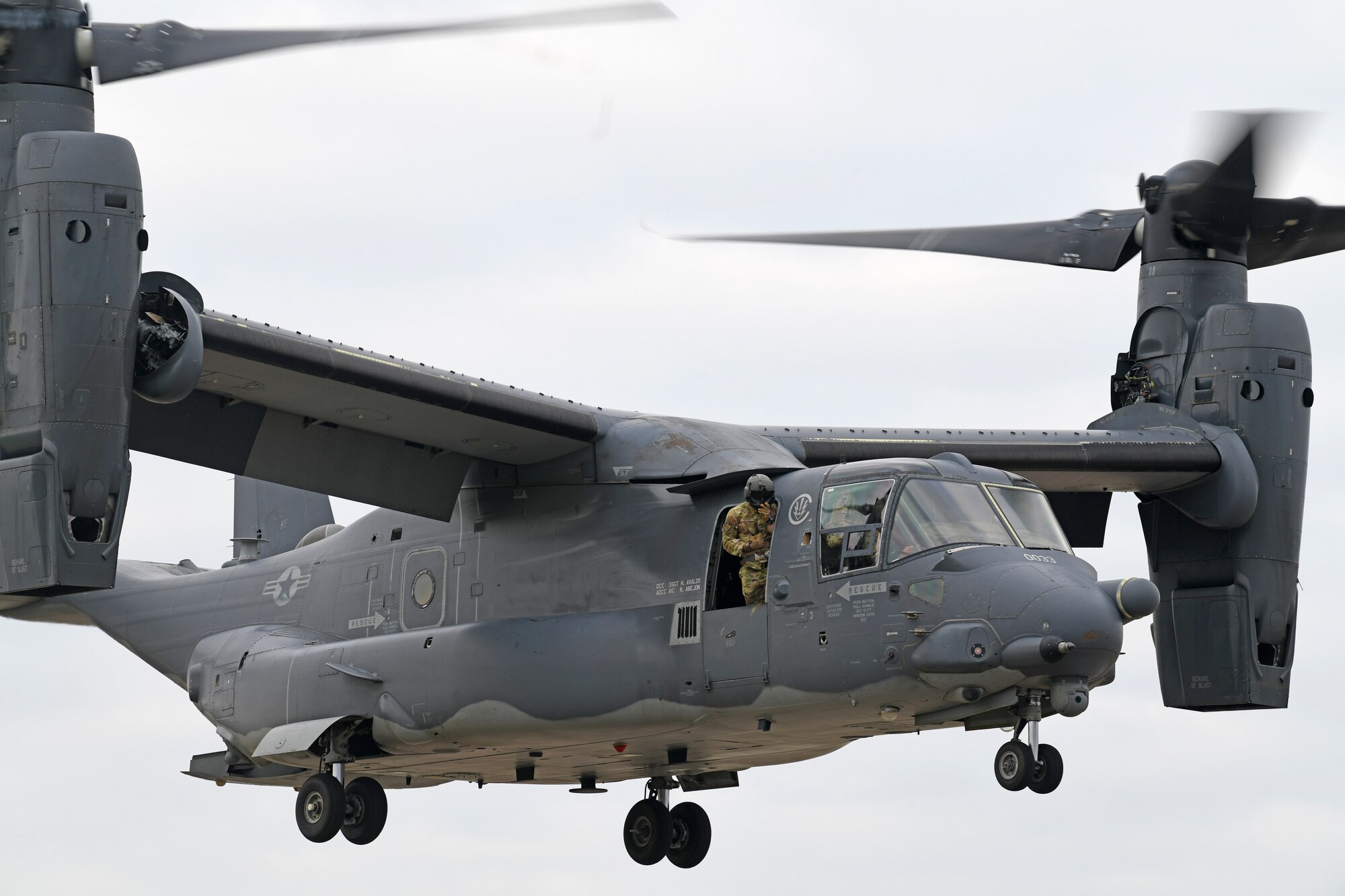 A CV-22 Osprey aircraft assigned to the 352nd Special Operations Wing hovers above a set of mattress pads during emergency landing training at Royal Air Force Mildenhall, England, Oct. 19, 2020. CV-22 aircrew and 752nd Special Operations Aircraft Maintenance Squadron maintainers conducted the training to enhance readiness and emphasize safety in the event of landing gear malfunctions. (U.S. Air Force photo by Staff Sgt. Mackenzie Mendez)