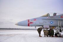 U.S. Marine Corps aircraft mechanics assigned to the Marine Fighter Attack Squadron (VMFA) 232 inspect an F/A-18 Hornet at Eielson Air Force Base, Alaska, Oct. 20, 2020.