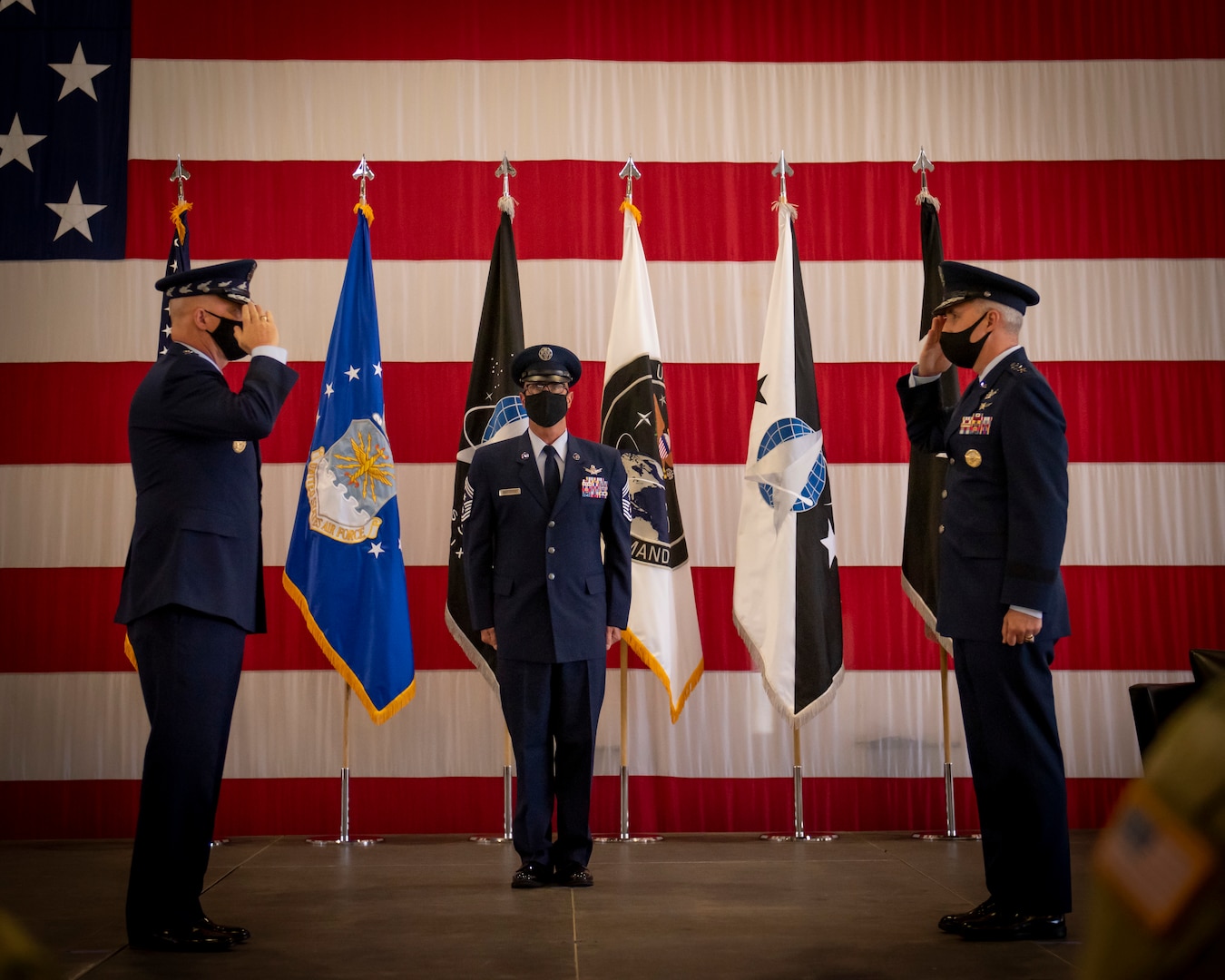 Gen. John W. “Jay” Raymond, U.S. Space Force Chief of Space Operations, receives a salute from Lt. Gen. Stephen N. Whiting, first commander of the newly re-designated Space Operations Command, during the activation ceremony at Peterson Air Force Base, Colo., Oct 21, 2020.