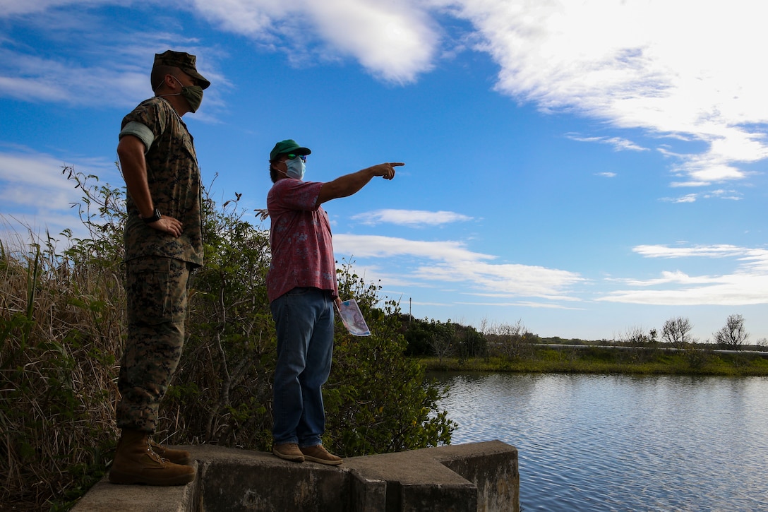 U.S. Marine Corps Lt. Col. Timothy Pochop, director, Environmental Compliance and Protection Division, and Erik Franklin, assistant research professor, Hawai’i Institute of Marine Biology, discuss the future of the Nu’upia Ponds, Marine Corps Base Hawaii, Oct. 19, 2020. The visit between base environmental specialists and local Hawaiian subject matter experts aimed to ensure that protected species and habitats aboard MCBH continue to receive the best care possible. (U.S. Marine Corps photo by Lance Cpl. Shane Linder)