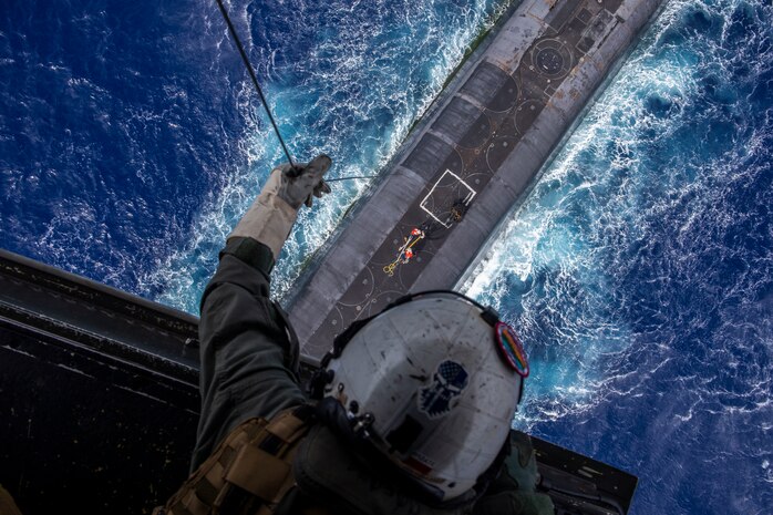 U.S. Marine Corps Staff Sgt. Ruben Arzate, attached to the "Lucky Red Lions" of Marine Medium Tiltrotor Squadron 363, lowers a payload from an MV-22B Osprey to the Ohio-class ballistic-missile submarine USS Henry M. Jackson in the vicinity of the Hawaiian Islands. Underway replenishment sustains the fleet anywhere/anytime. This event was designed to test and evaluate the tactics, techniques, and procedures of U.S. Strategic Command's expeditionary logistics and enhance the overall readiness of our strategic forces. (U.S. Marine Corps photo by Cpl. Matthew Kirk)