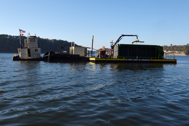 The crew of the PRIDE of the Cumberland places debris into an air curtain burner on a new floating barge Oct. 21, 2020 in Lake Cumberland near Waitsboro Recreation Area in Somerset, Kentucky. (USACE Photo by Lee Roberts)
