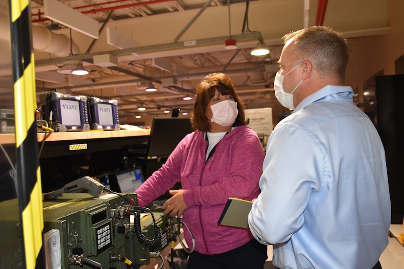 Photo of Cheryl Bachart discussing her work processes with team auditor Dan Wyrick