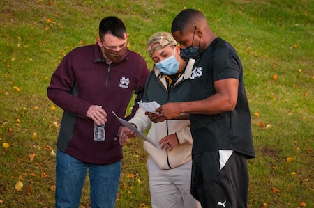 Soldiers read a riddle for a scavenger hunt