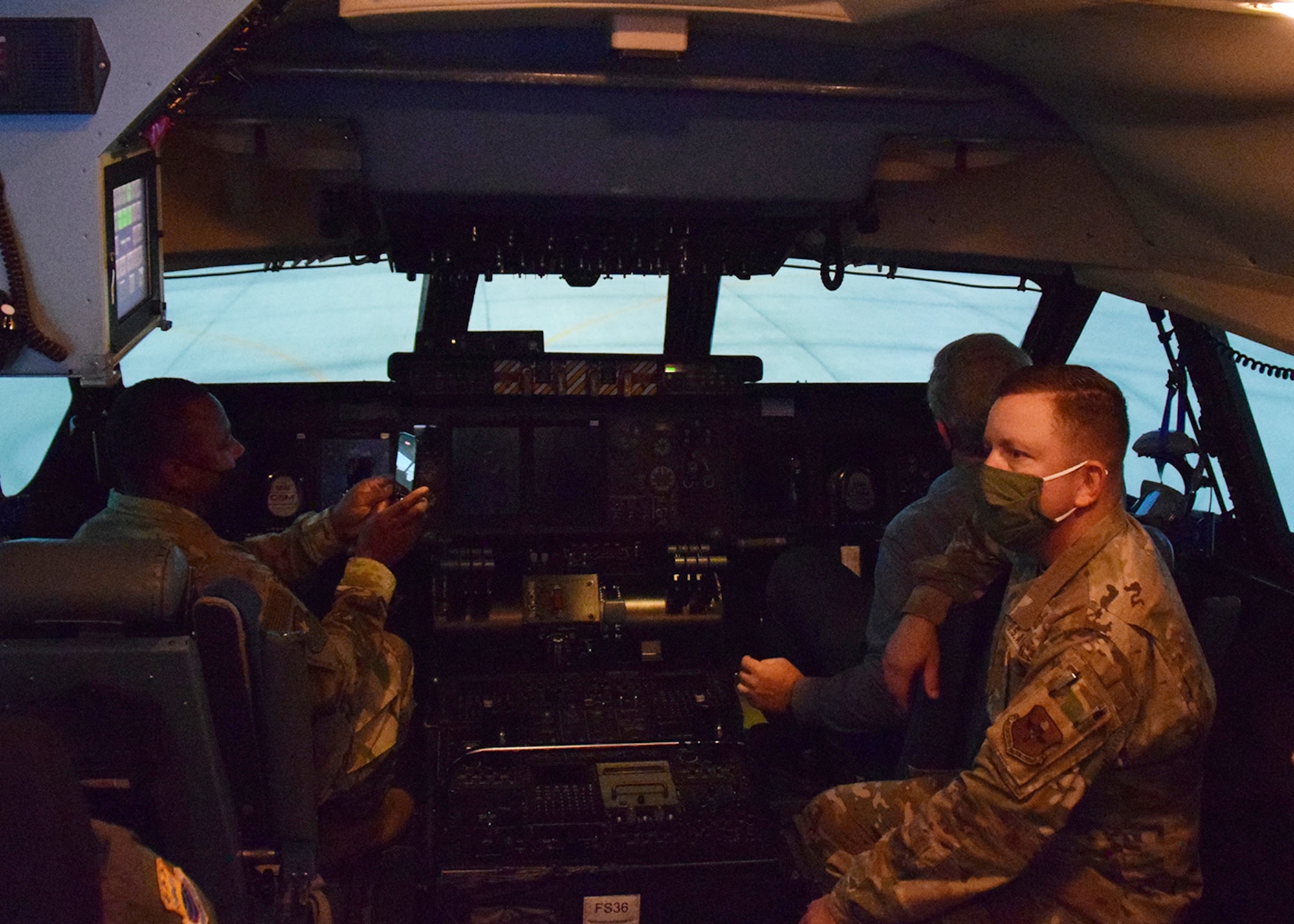 Chief Master Sgt. Carey S. Jordan, 502nd Installation Support Group command chief, Mark J. Tharp, 502nd ISG technical director, and Col. Steven A. Strain, 502nd ISG commander, tour the C-5M Super Galaxy flight simulator at the 433rd Airlift Wing’s flight training facility Oct. 21, 2020 at Joint Base San Antonio-Lackland, Texas. (U.S. Air Force photo by Iram Carmona)