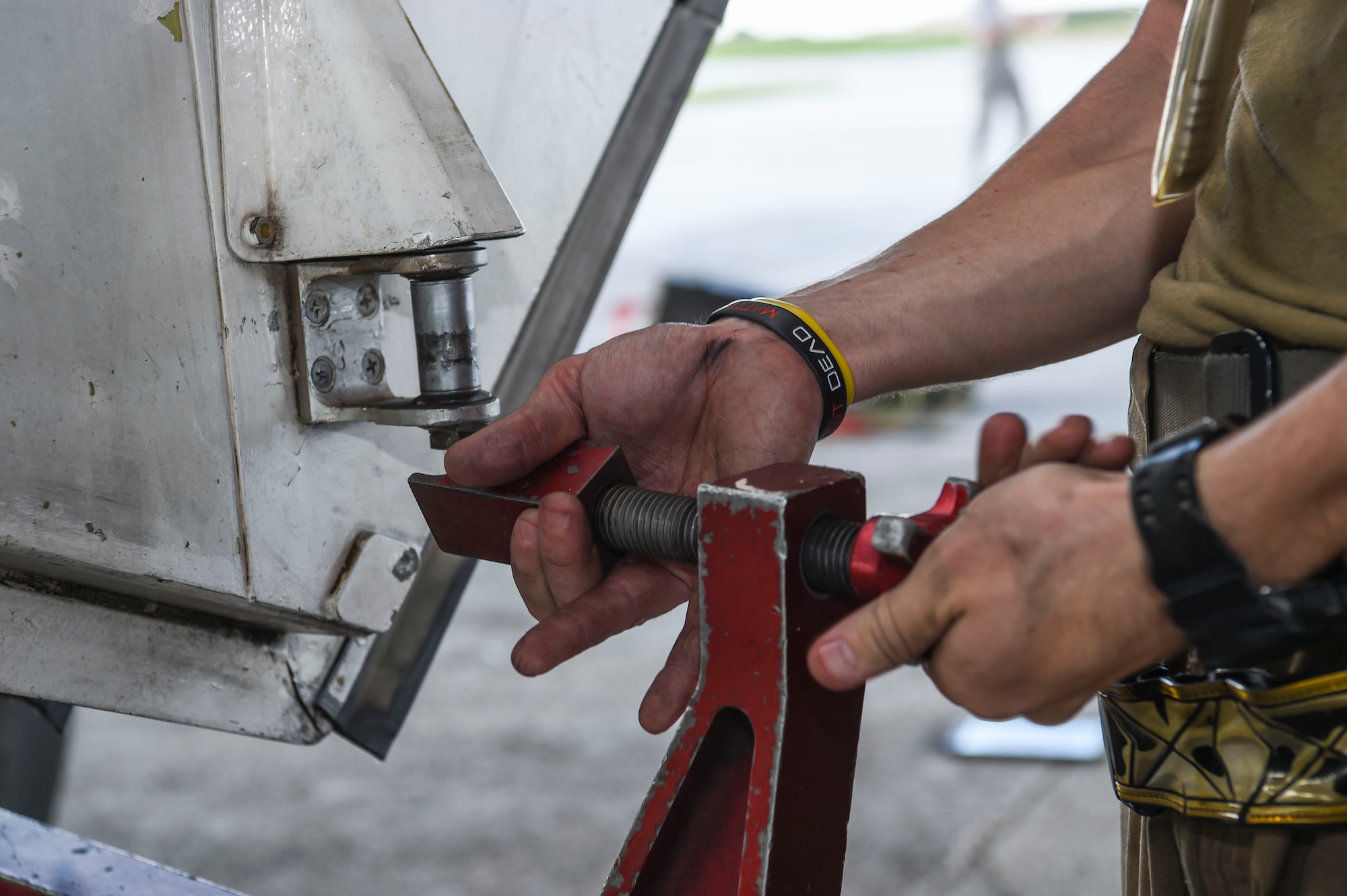 Senior Airman Andrew Burris, 9th Expeditionary Bomb Squadron crew chief, tightens a B-1B Lancer aircraft main landing gear, during a Bomber Task Force deployment, at Andersen Air Force Base, Guam, Oct. 20, 2020.