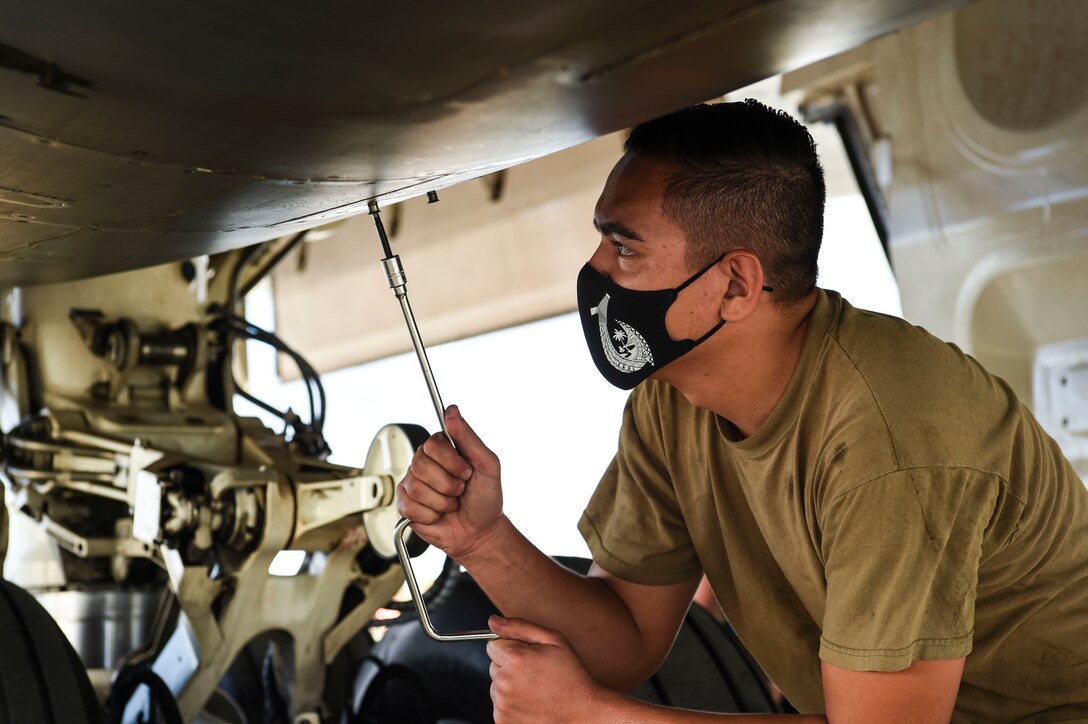 Senior Airman Zach Cruz, 9th Expeditionary Bomb Squadron crew chief, closes a panel after inspecting a B-1B Lancer auxiliary power unit during a Bomber Task Force deployment at Andersen Air Force Base, Guam, Oct. 20, 2020.