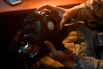 An Airman assigned to the 48th Fighter Wing inspects a gas mask at Royal Air Force Lakenheath, England, Oct. 5, 2020. The individual protective equipment section are essential to base wide exercises by ensuring Liberty Wing Airmen are prepared by providing training and deployment gear base wide. (U.S. Air Force photo by Rhonda Smith)