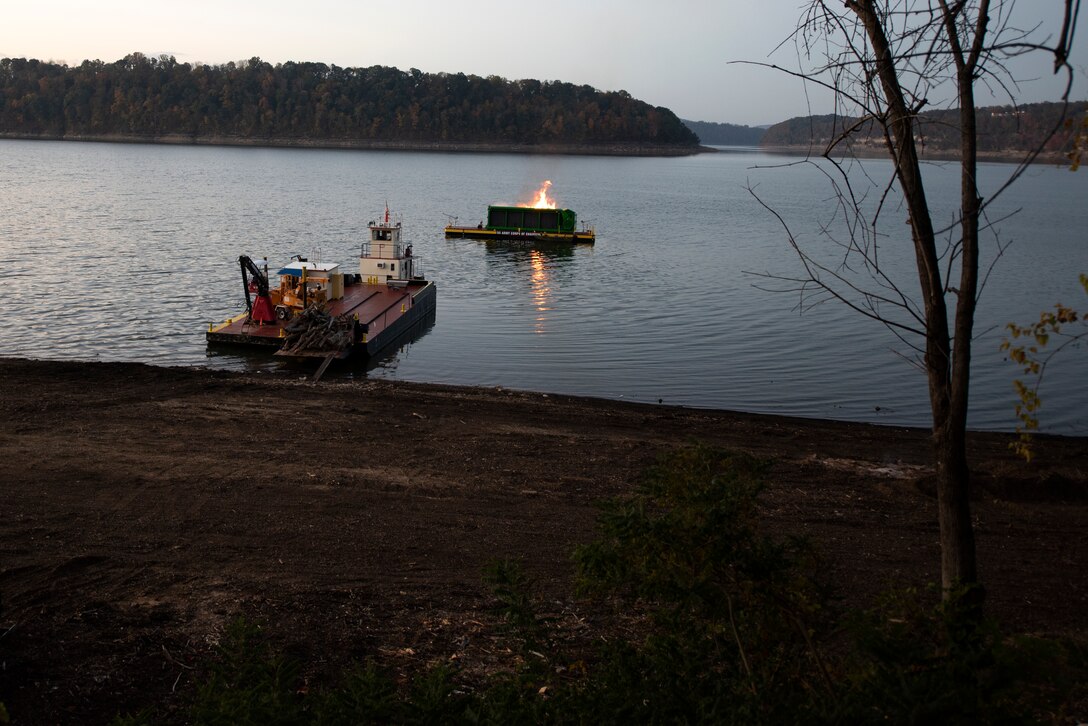 A new floating barge and air curtain burner incinerates debris early morning Oct. 21, 2020 on Lake Cumberland near Waitsboro Recreation Area in Somerset, Kentucky. (USACE Photo by Lee Roberts)
