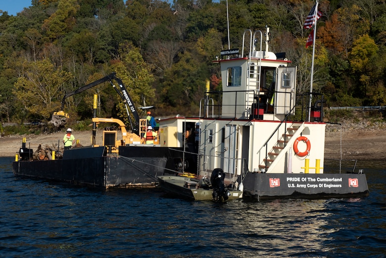 The crew of the PRIDE of the Cumberland places debris into an air curtain burner on a new floating barge Oct. 21, 2020 in Lake Cumberland near Waitsboro Recreation Area in Somerset, Kentucky. (USACE Photo by Lee Roberts)