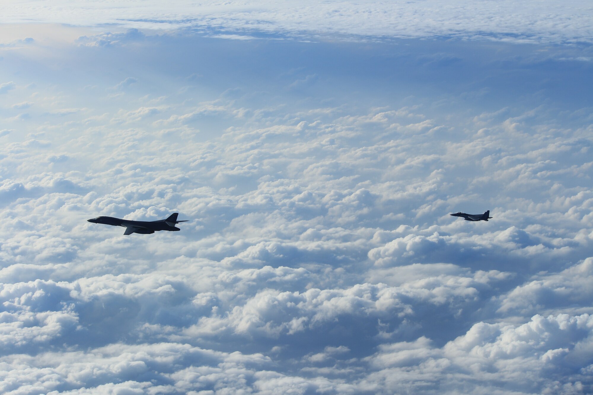A B-1B Lancer, assigned to the 9th Expeditionary Bomb Squadron, Dyess Air Force Base, Texas, conducts training with a Koku-Jieitai (Japan Air Self Defense Force) F-15 fighter in the vicinity of the Sea of Japan, October 20, 2020.