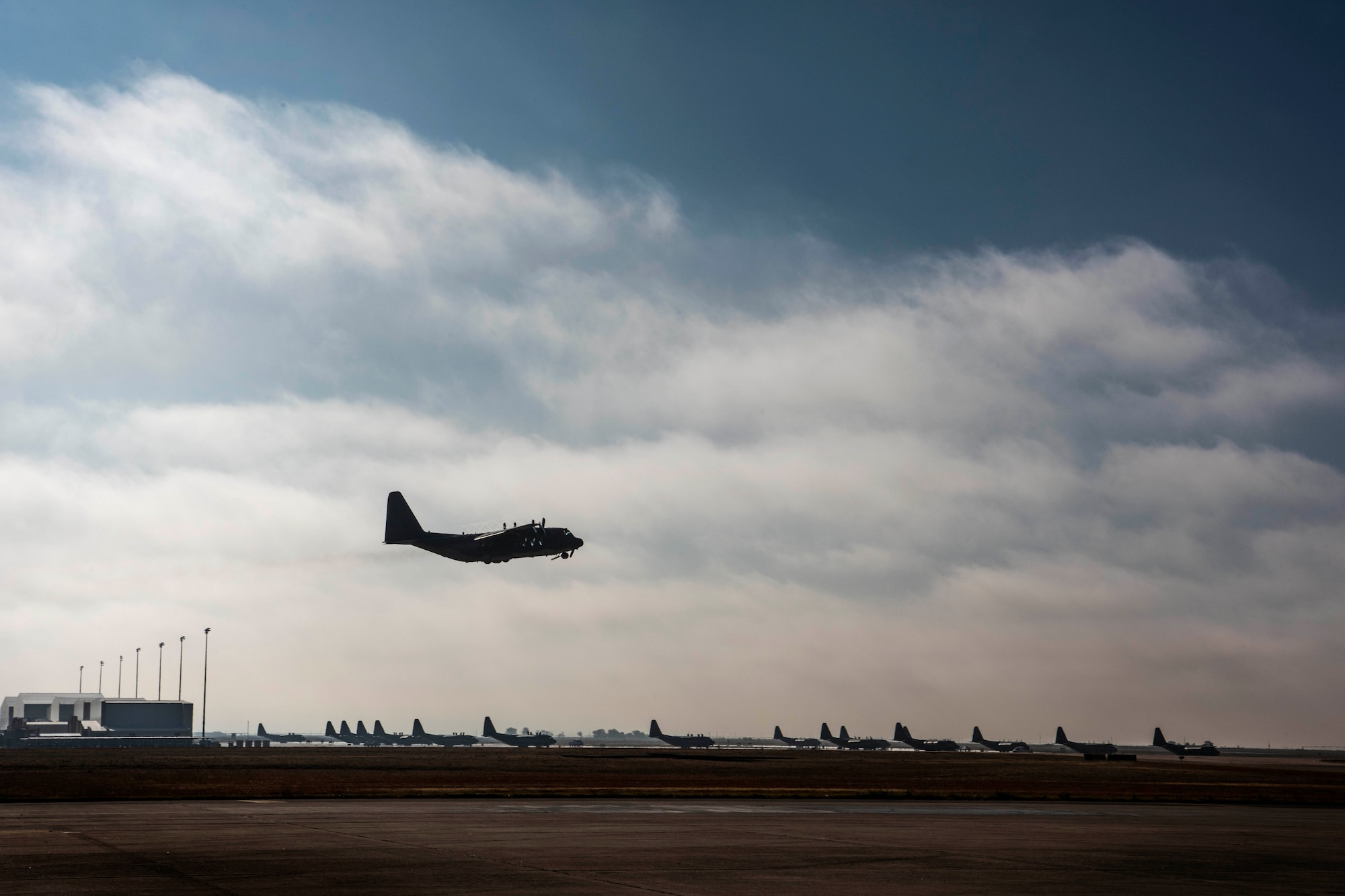 An AC-130W Stinger II gunship, Tail No. 1303, flies over the runway at Cannon Air Force Base, N.M., during its final flight prior to retirement Oct. 19, 2020. The aircraft traveled to Sheppard Air Force Base, Texas, where it will permanently stay and be used as a weapons training system for Airmen in weapons school. (U.S. Air Force photo by Staff Sgt. Luke Kitterman)