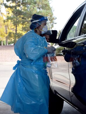 Medical professional hand COVID-19 test to patient