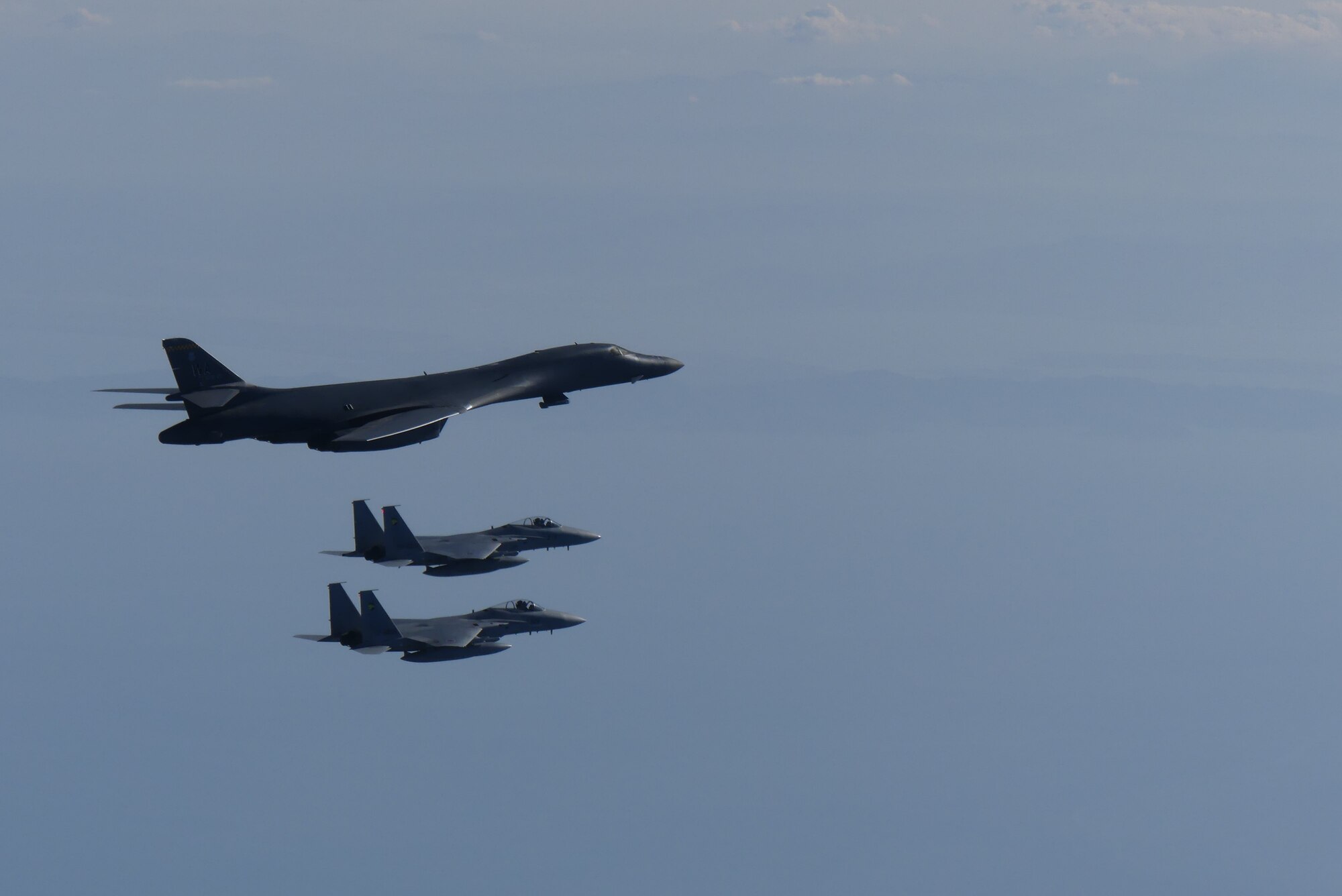 A B-1B Lancer, assigned to the 9th Expeditionary Bomb Squadron, Dyess Air Force Base, Texas, conducts training with two Koku-Jieitai (Japan Air Self Defense Force) F-15 fighters in the vicinity of the Sea of Japan, October 20, 2020.