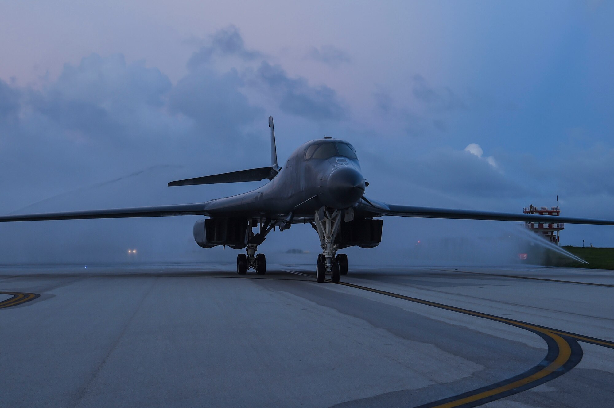 A water salute is performed as a B-1B Lancer aircraft taxis during a Bomber Task Force deployment at Andersen Air Force Base, Guam, Oct. 21, 2020.