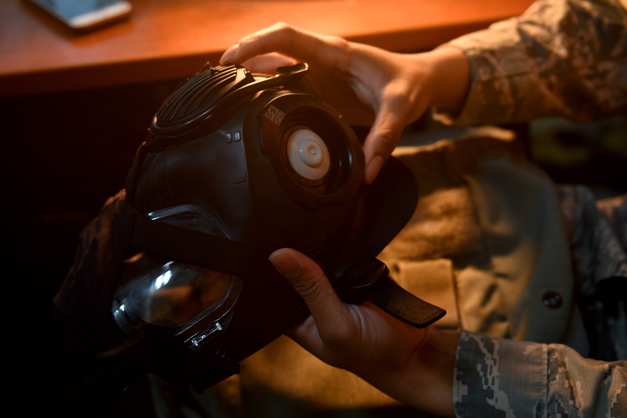 An Airman assigned to the 48th Fighter Wing inspects a gas mask at Royal Air Force Lakenheath, England, Oct. 5, 2020. The individual protective equipment section are essential to base wide exercises by ensuring Liberty Wing Airmen are prepared by providing training and deployment gear base wide. (U.S. Air Force photo by Rhonda Smith)
