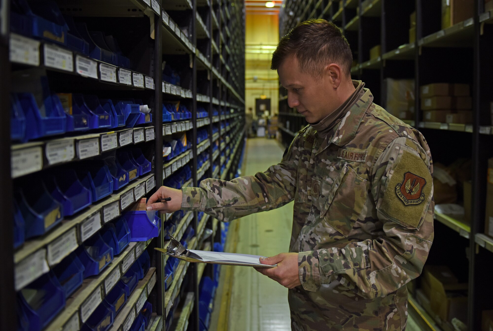 U.S. Air Force Master Sgt. Bruno Mosqueira, Logistics Readiness Squadron Materiel Management Flight storage and issue section chief, inspects inventory at Royal Air Force Lakenheath, England, Oct. 5, 2020. M-Flight manages three warehouses that collectively houses 1.3 million assets including aircraft parts and training and deployment gear. (U.S. Air Force photo by Airman 1st Class Rhonda Smith)