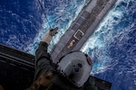 Marine attached to “Lucky Red Lions” of Marine Medium Tiltrotor Squadron 363 lowers payload from MV-22B Osprey to USS Henry M. Jackson in vicinity of Hawaiian Islands, Pacific Ocean, October 21, 2020 (U.S. Marine Corps/Matthew Kirk)