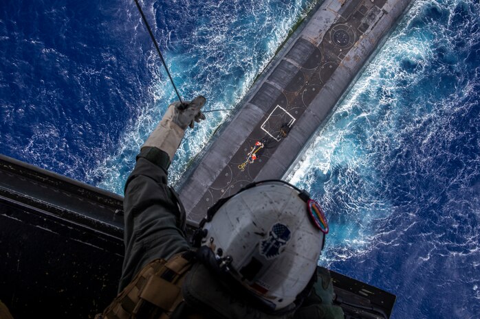 U.S. Marine Corps Staff Sgt. Ruben Arzate, attached to the "Lucky Red Lions" of Marine Medium Tiltrotor Squadron 363, lowers a payload from an MV-22B Osprey to the Ohio-class ballistic-missile submarine USS Henry M. Jackson (SSBN 730) in the vicinity of the Hawaiian Islands. Underway replenishment sustains the fleet anywhere/anytime. This event was designed to test and evaluate the tactics, techniques, and procedures of U.S. Strategic Command's expeditionary logistics and enhance the overall readiness of our strategic forces.