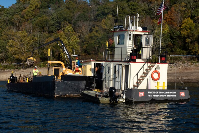 The crew of the PRIDE of the Cumberland places debris into an air curtain burner on a new floating barge Oct. 21, 2020 in Lake Cumberland near Waitsboro Recreation Area in Somerset, Kentucky. (USACE Photo by Lee Roberts)