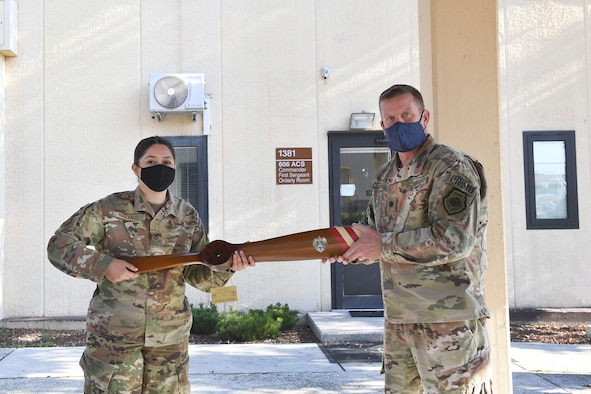 U.S. Air Force Lt. Col. Brian Robertson, 606th Air Control Squadron commander, presents Senior Airman Maria Naranjo, 606th ACS cyber transport systems technician, with an award for the 2019 U.S. Air Forces in Europe and Air Forces Africa Airman of the Year at Aviano Air Base, Italy, Oct. 14, 2020. During the presentation, Robertson thanked her for her dedication and contributions to the unit, as well as her fellow Airmen.