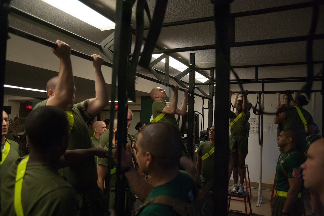 Recruits of Special Training Company, Support Battalion, do pullups during a physical training session July 10, 2013, Parris Island, S.C. Some recruits are removed from normal training due to medical or physical conditions that prevent them from safely progressing through recruit training. While assigned to the company, recruits rehabilitate in order to return to training where they left off. Approximately 20,000 recruits come to Parris Island annually for the chance to become United States Marines by enduring 13 weeks of rigorous, transformative training. Parris Island is home to entry-level enlisted training for 50 percent of males and 100 percent of for females in the Marine Corps. (Photo by Lance Cpl. David Bessey)