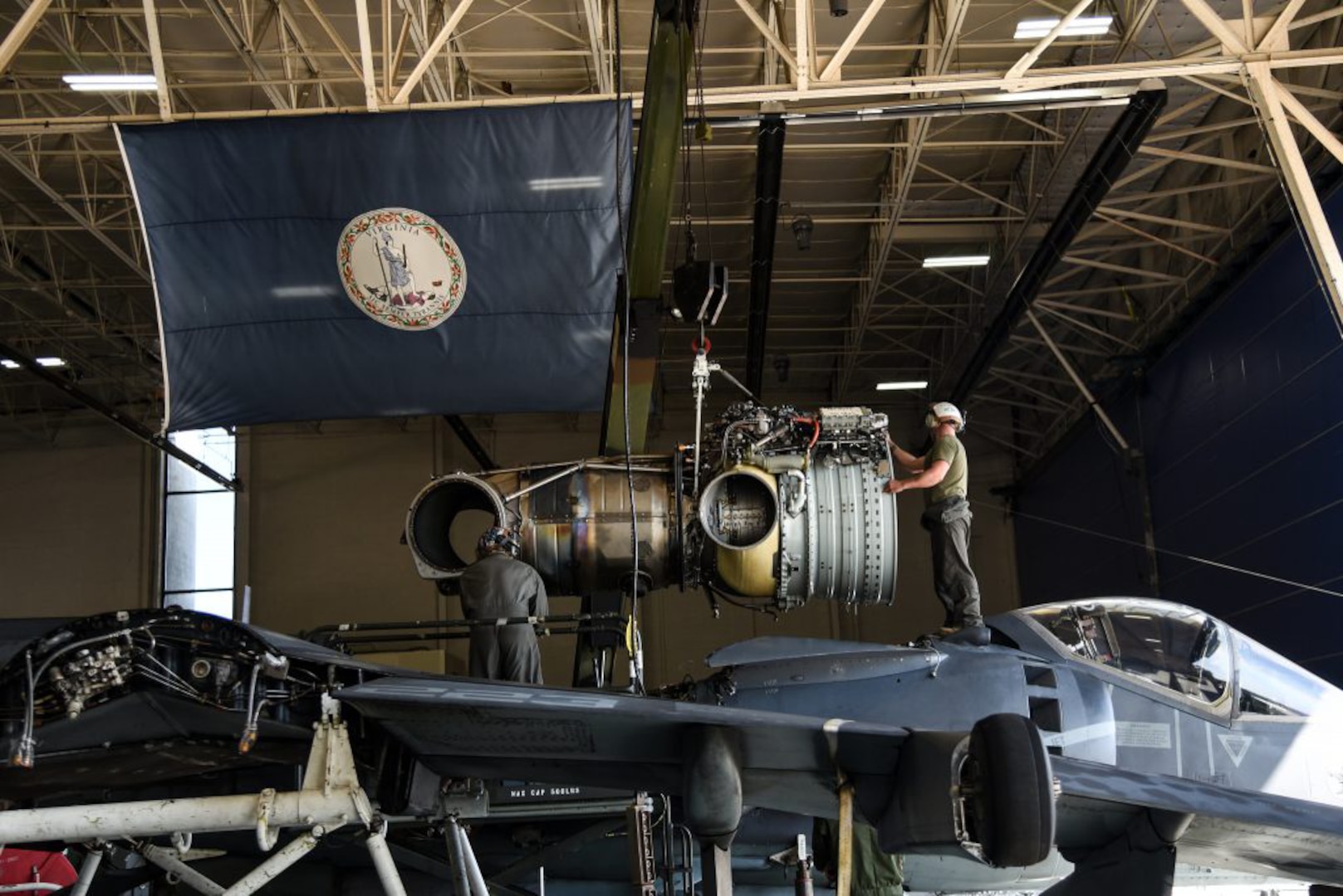 Marines assigned to Marine Attack Squadron 223, Cherry Point, North Carolina, install a new engine in an AV-8B Harrier jet Oct. 1, 2020, at the Virginia National Guard’s Army Aviation Support Facility in Sandston, Virginia.
