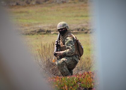 200819-N-GF511-0008 POINT MUGU, Calif. (Aug. 19, 2020) -- Civil Engineer Corps Officers School (CECOS) Basic Qualification Course student Ensign Cordell Langley surveys an area for a potential alternative supply route and bridge during a five-day field training exercise (FTX). As an integral part of the school's training cycle, the FTX challenges future Civil Engineer Corps officers to operate as a team during scenario missions in the field. Students learn basic principles and skill sets, such as leadership, teamwork, and accountability, to help them be successful leading Seabees in naval construction force expeditionary units. (U.S. Navy photo by Amber Vaglica)