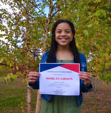 Morgan Gibson, an eighth grade student at Hanscom Middle School, poses with her iCivics National Equity Fellowship acceptance letter at Hanscom Air Force Base, Mass., Oct. 23. Gibson was one of 22 students selected nation-wide to participate in the student-leadership program that works to better the equity in civics in school curriculums. (courtesy photo)